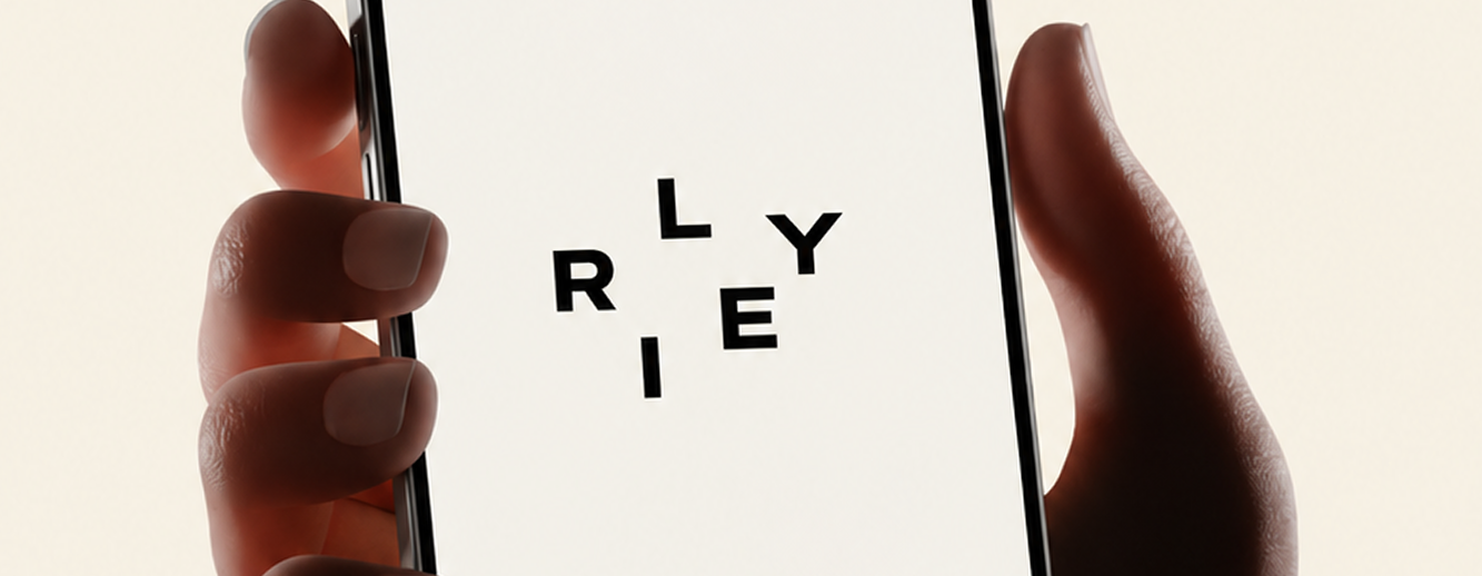 RILEY lettering on a phone held in a hand.